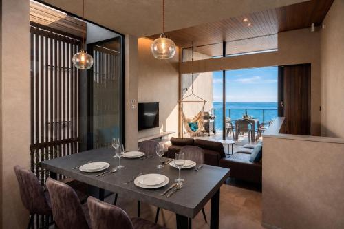 a dining room with a table and a view of the ocean at nagisa awajishima in Awaji