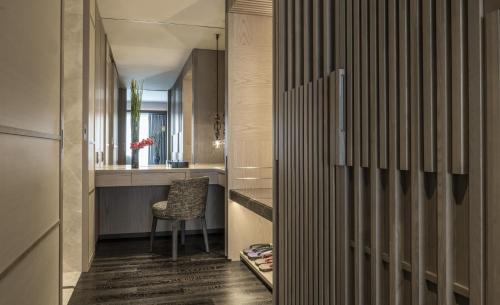 a hallway with a table and a chair in a room at Four Seasons Hotel Kyoto in Kyoto