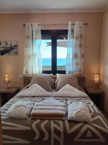 a bedroom with a bed with a view of the ocean at Domaine La Chiusella in Monticello