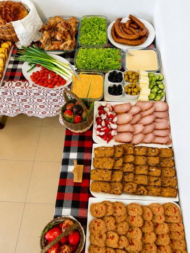 a table with many different types of food on it at Conacul Birtoc Refugiu Tradițional în Maramureș in Văleni
