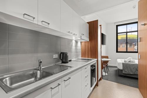 a kitchen with a sink and a counter top at Comfort Inn Geelong in Geelong