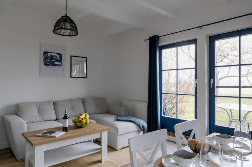 a living room with a couch and a table at Am Achterwasser DORF 12 in Rankwitz