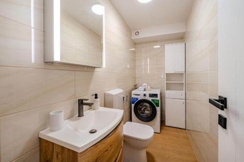a bathroom with a sink and a washing machine at Angelina in Jakišnica