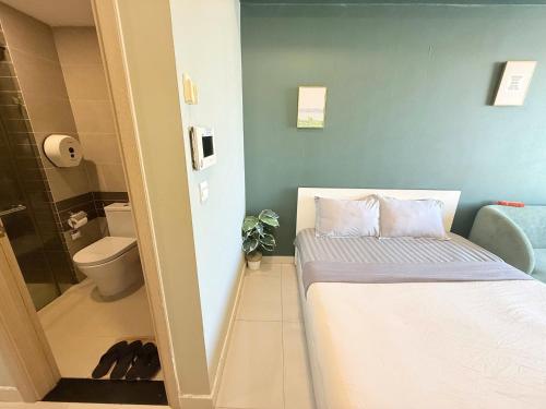 a small bathroom with a bed and a toilet at Stay With Me CBD Apartment - Rivergate Building in Ho Chi Minh City