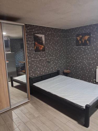 a large bed in a room with a mirror at Гостевая комната in Kyiv