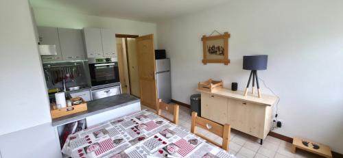 a kitchen with a table and a counter top at MV Vacances in Les Rousses