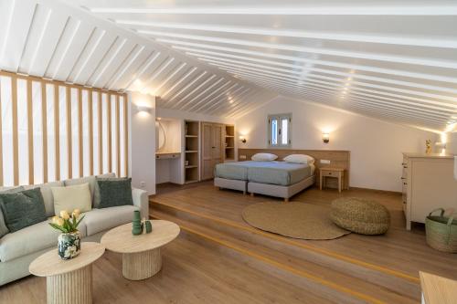 a living room with a bed and a couch at Remetzo Village in Lixouri