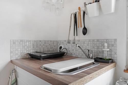 a kitchen counter with a sink and a stove at Chata obklopena přírodou in Malé Žernoseky