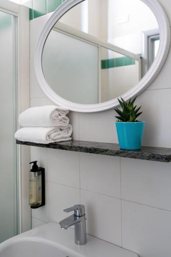 a bathroom with a sink and a mirror at Hotel Altamarea in Misano Adriatico