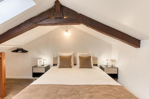 a bedroom with a large bed with two night stands at Le splendide - modern & cocooning in Tarbes