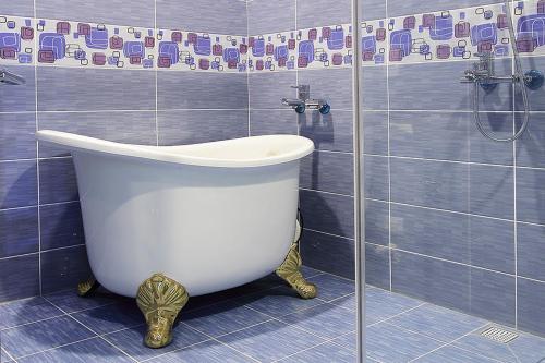 a bath tub in a bathroom with a shower at 維邇莊園-Weir manor 傑克堡 in Tainan