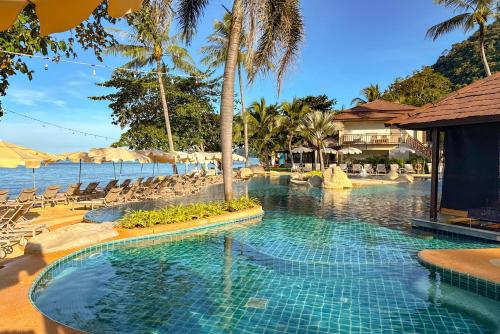 a swimming pool next to a beach with a resort at Kacha Resort & Spa, Koh Chang in Ko Chang