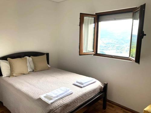 a bedroom with a bed with two towels on it at Casa da Laija - Vistas rio - "Gerês" in Geres
