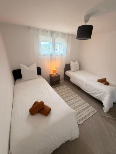 a bedroom with two beds with towels on them at Lumière du paradis in Villes-sur-Auzon