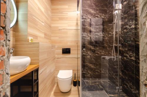a bathroom with a toilet and a glass shower at 3-217 Rybalsky, Naberezhno Rybalska 3, Kyiv centre, panoramic city view, 15 kW backup power, Petrovdom Apartment in Kyiv