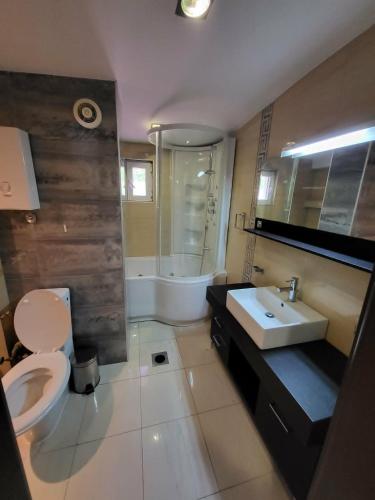 a bathroom with a white toilet and a sink at Nikita Lux in Lagadin