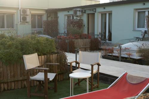 three chairs and a slide in a yard at WellHome Asti Premium Apartments with Private Terrace & Garden in Asti