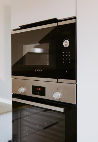 a microwave oven sitting on top of a stove at Villa de Meslay in Montaigu-Vendée