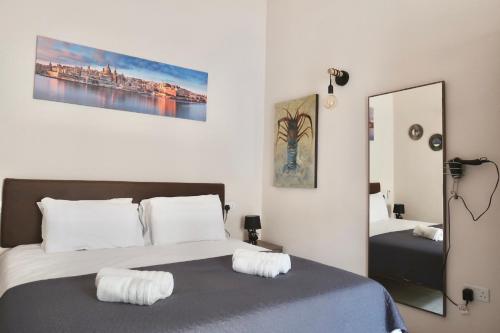 a bedroom with a bed with two white pillows at Guesthouse Historical Palacinho de São Antonio in Birgu