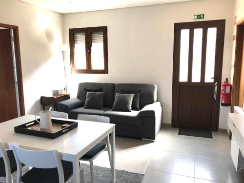a living room with a couch and a table at Casa da Laija - Vistas rio - "Gerês" in Geres