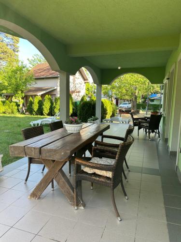 a wooden table and chairs on a patio at Vila Plaza-1 in Bela Crkva