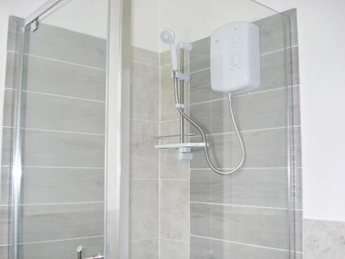 a shower with a glass door in a bathroom at Hydaway in Bacton