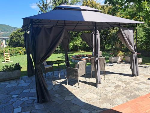 a gazebo with a table and chairs under it at Agriturismo Le cicale e la formica in Casarza Ligure