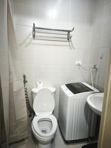 a small bathroom with a toilet and a sink at Condo unit open for staycation in Manila