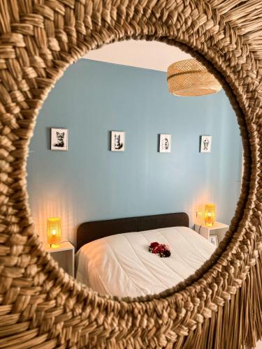 a bedroom with a bed and a mirror at Maison Paillette à Saint Saturnin in Saint-Saturnin-lès-Avignon