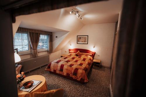 a hotel room with a bed and a table at Landhotel Herscheider Mühle in Herscheid