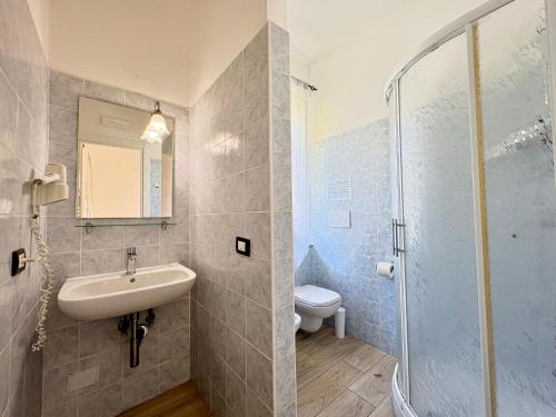 a bathroom with a sink and a toilet and a shower at Affittacamere Il Veliero in Levanto
