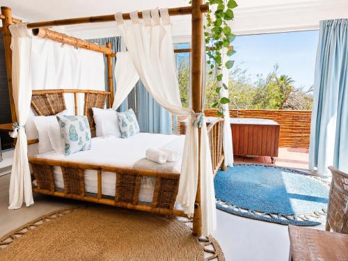 a bed in a room with a window at VistaBlu Camps Bay in Cape Town