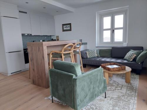 a living room with a couch and a table at Chic & Cozy Lake View Apartment in Seeboden