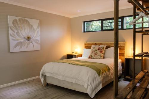 a bedroom with a bunk bed and two windows at Rest at Chabivin in Stellenbosch