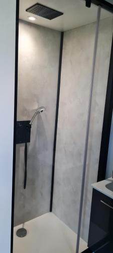a shower stall with a shower head in a room at Studio Mountain Star Dream in Sainte-Marie-de-Cuines