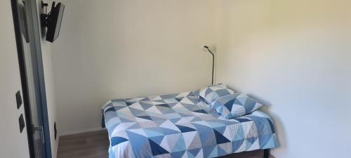 a bedroom with a bed with a blue at Studio Mountain Star Dream in Sainte-Marie-de-Cuines