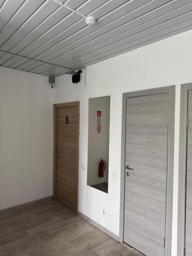 an empty room with two doors and a fire hydrant at Abay Hostel in Almaty