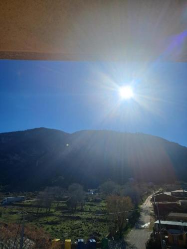 a view of a mountain with the sun in the sky at Mountain View Village Life in Bárig