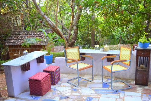 a table and chairs sitting on a patio at Namaste Yoga Farm in Gokarna