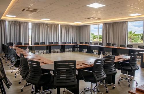a large conference room with a long table and chairs at Rosewood by Amaryllis Lilongwe in Lilongwe