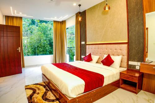 a bedroom with a large bed and a large window at Gems Munnar in Anachal