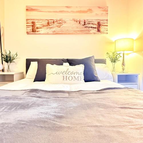 a bedroom with a bed with a welcome home pillow at The Forgate exchange in Worcester