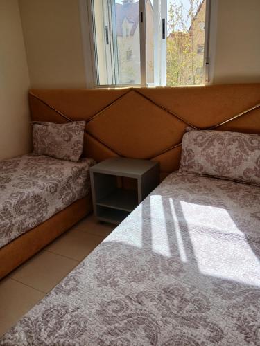 a bedroom with two beds and a window at Irini in Ifrane
