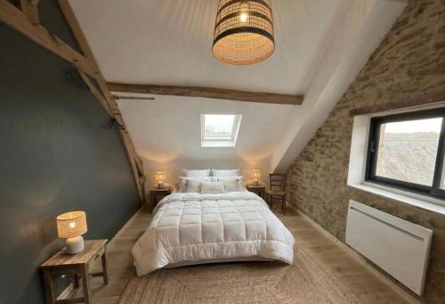 a bedroom with a large bed in a attic at 9 La Roche La Bergerie in Saint-Plantaire