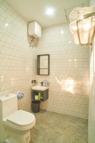 a bathroom with a toilet and a sink at Bustani Home Studio in Arusha