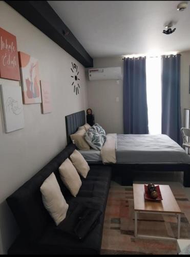 a living room with a couch and a bed at Studio Type Furnished Condo in Lapu Lapu City