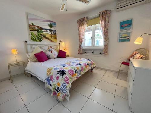 a bedroom with a bed and a window at Puerto Chico F in Playa Blanca
