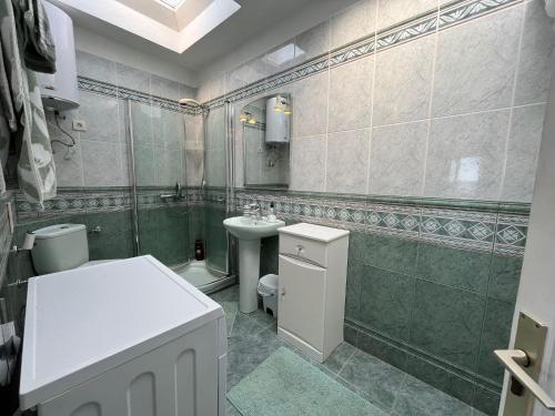 a bathroom with a sink and a toilet and a mirror at Puerto Chico F in Playa Blanca