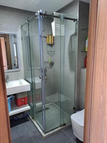 a glass shower in a bathroom with a toilet at Blue Horizon Mansouriah in Mohammedia