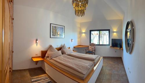 a bedroom with a large bed in a room at Casa Ronda in Charco del Palo